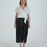 Black and white pinstripe high waisted sculptural skirt by Lumina Eligma
Architectural wool blend skirt with asymmetrical pleats
Designer black pinstripe skirt with modern tailoring
