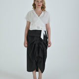 Black and white pinstripe high waisted sculptural skirt by Lumina Eligma
Architectural wool blend skirt with asymmetrical pleats
Designer black pinstripe skirt with modern tailoring
