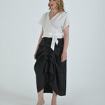 Black and white pinstripe high waisted sculptural skirt by Lumina Eligma
Architectural wool blend skirt with asymmetrical pleats
Designer black pinstripe skirt with modern tailoring
