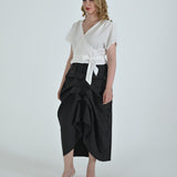 Black and white pinstripe high waisted sculptural skirt by Lumina Eligma
Architectural wool blend skirt with asymmetrical pleats
Designer black pinstripe skirt with modern tailoring
