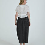 Black and white pinstripe high waisted sculptural skirt by Lumina Eligma
Architectural wool blend skirt with asymmetrical pleats
Designer black pinstripe skirt with modern tailoring
