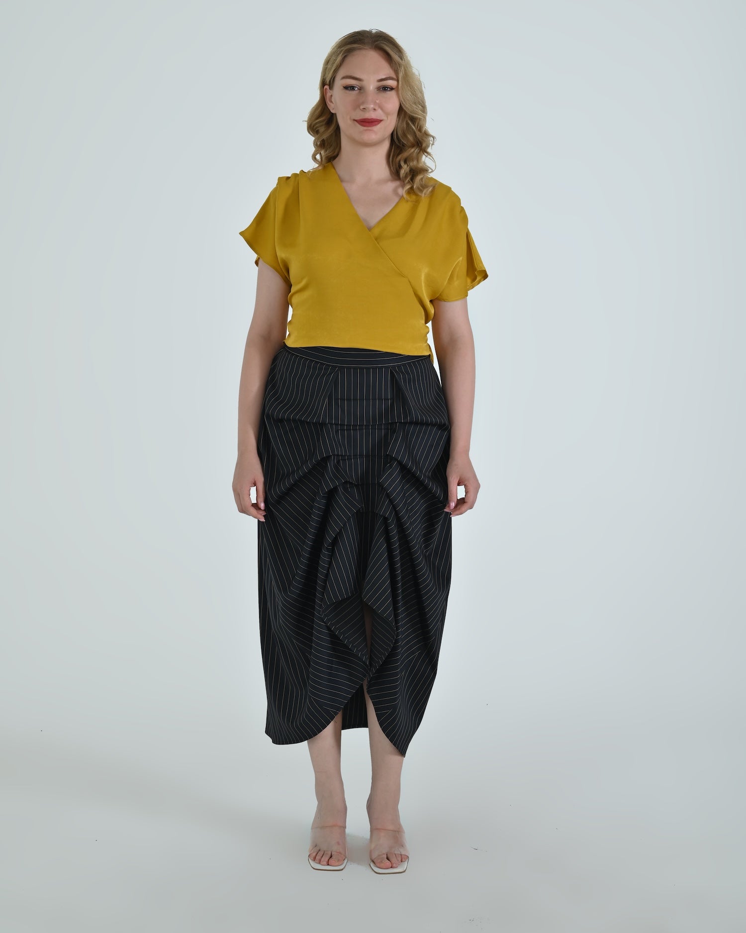 High-waisted sculptural skirt in structured wool blend by Lumina Eligma
Architectural wool-blend skirt with pinstripes – Lumina Eligma
Luxury designer skirt with asymmetrical draping
Modern tailored skirt for women – Lumina Eligma
