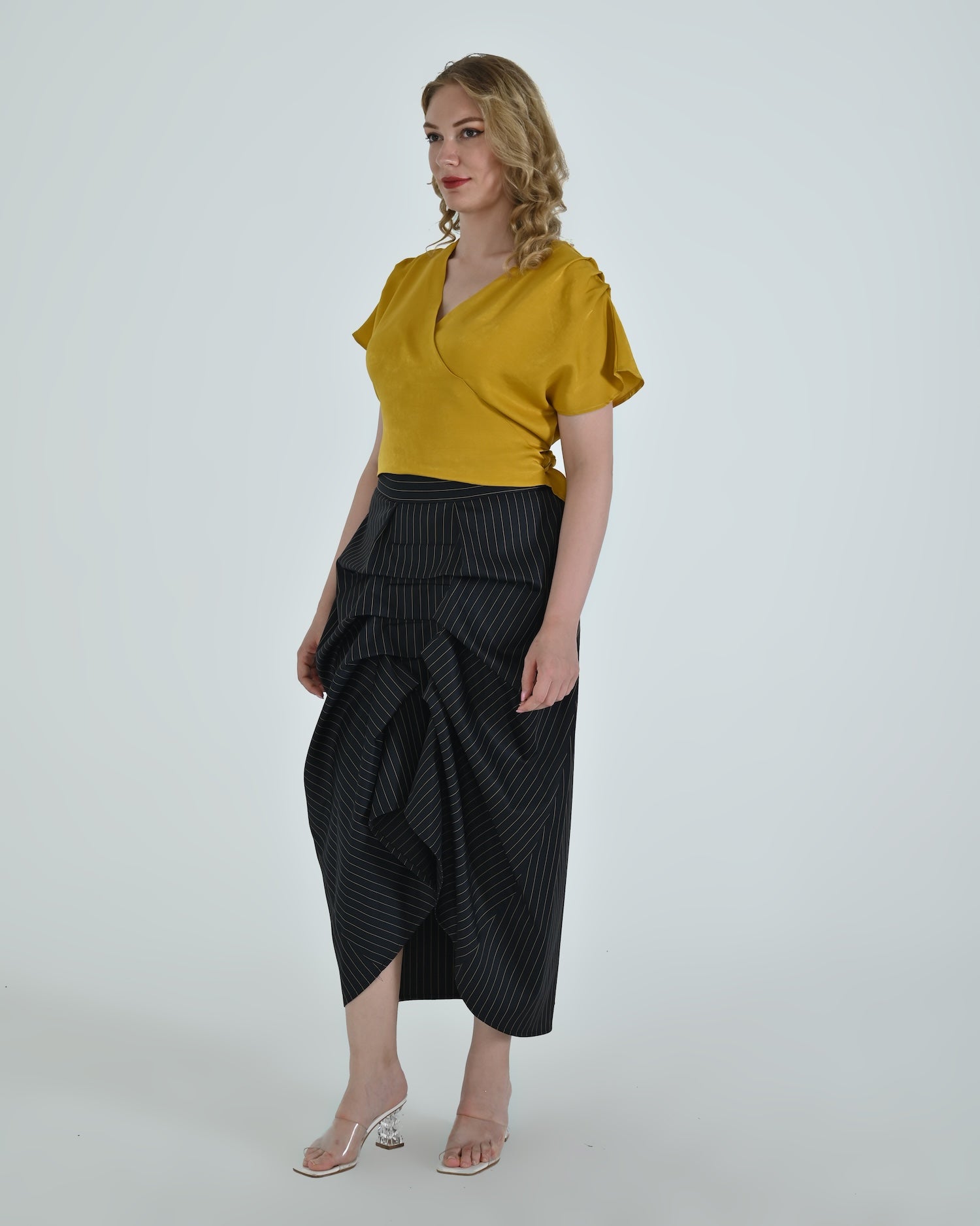 High-waisted sculptural skirt in structured wool blend by Lumina Eligma
Architectural wool-blend skirt with pinstripes – Lumina Eligma
Luxury designer skirt with asymmetrical draping
Modern tailored skirt for women – Lumina Eligma
