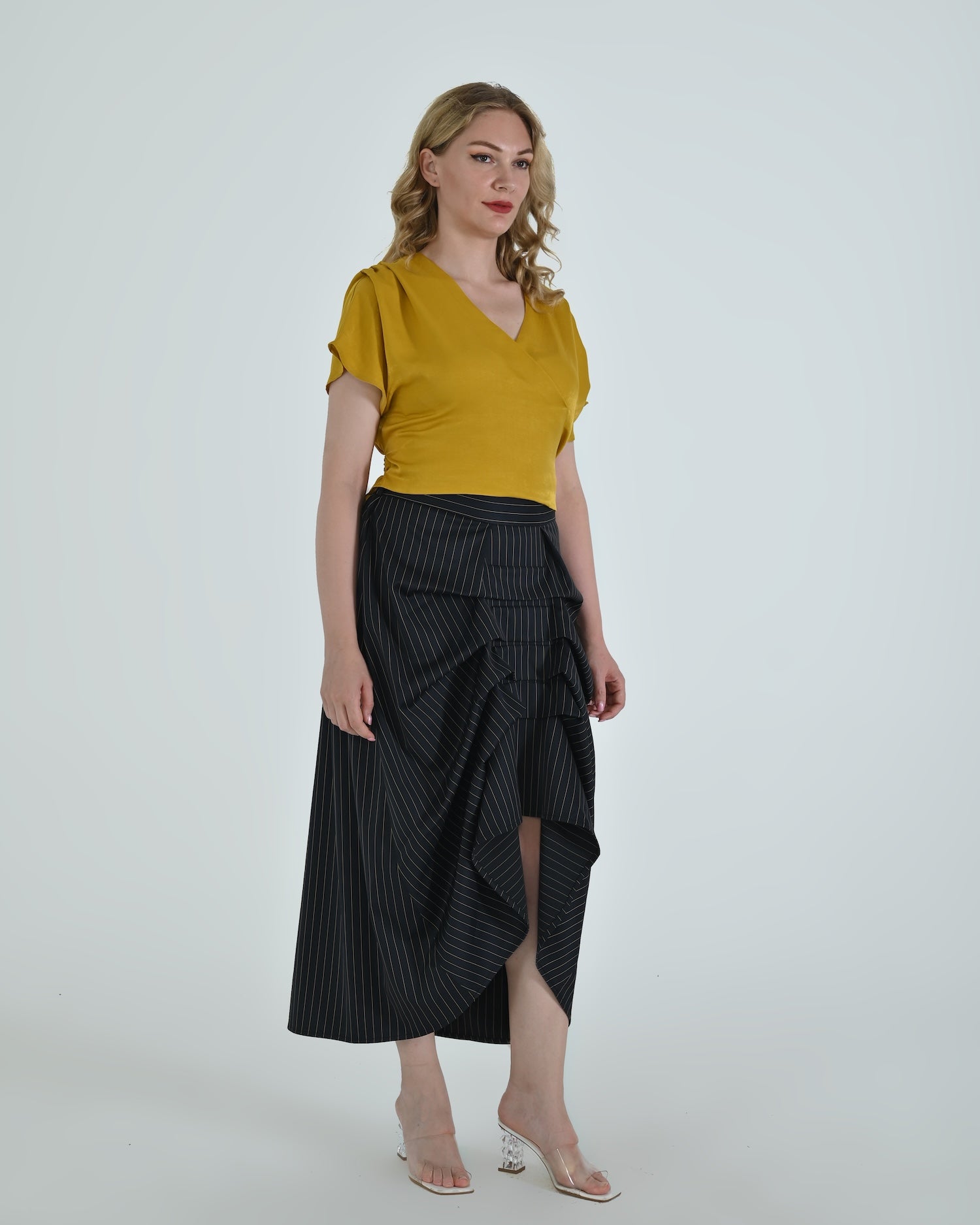 High-waisted sculptural skirt in structured wool blend by Lumina Eligma
Architectural wool-blend skirt with pinstripes – Lumina Eligma
Luxury designer skirt with asymmetrical draping
Modern tailored skirt for women – Lumina Eligma
