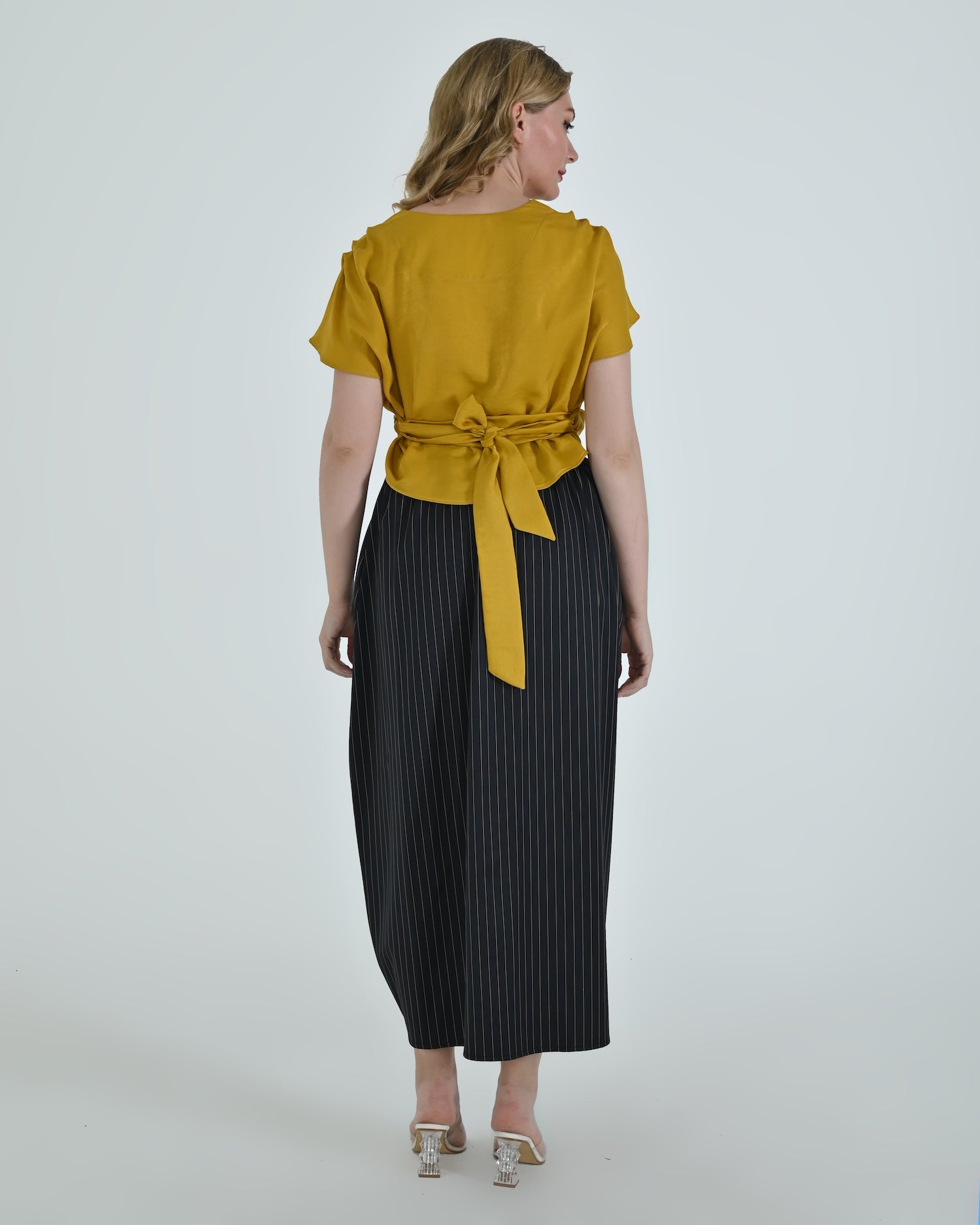 High-waisted sculptural skirt in structured wool blend by Lumina Eligma
Architectural wool-blend skirt with pinstripes – Lumina Eligma
Luxury designer skirt with asymmetrical draping
Modern tailored skirt for women – Lumina Eligma
