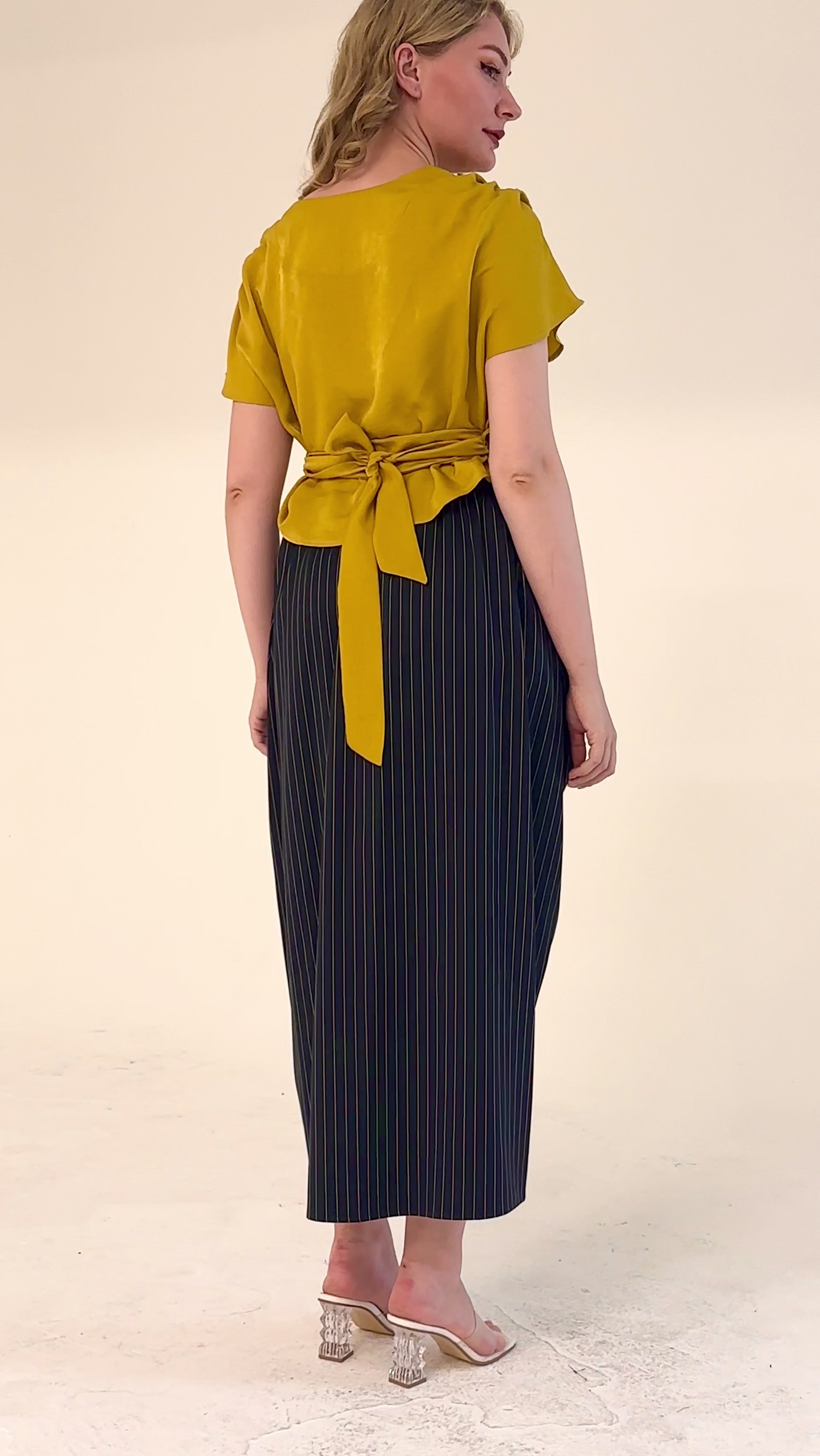 High-waisted sculptural skirt in structured wool blend by Lumina Eligma
Architectural wool-blend skirt with pinstripes – Lumina Eligma
Luxury designer skirt with asymmetrical draping
Modern tailored skirt for women – Lumina Eligma
